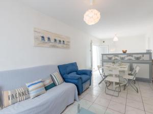 sala de estar con sofá azul y mesa en Holiday Home Les Sables by Interhome en Royan