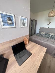 Cette chambre dispose d'un ordinateur portable sur un comptoir en bois. dans l'établissement Appt lumineux - 2 chambres - Mer et commerces, à Berck-sur-Mer
