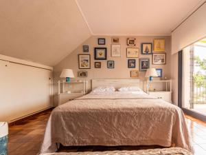 a bedroom with a bed and pictures on the wall at Holiday Home El Garrofer by Interhome in Comarruga