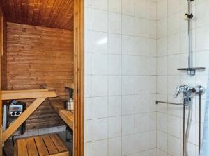 a bathroom with a shower and a toilet in it at Holiday Home Mäkitupa by Interhome in Syöte