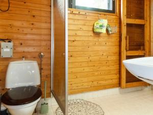 a bathroom with a toilet and a sink at Holiday Home Mäkitupa by Interhome in Syöte