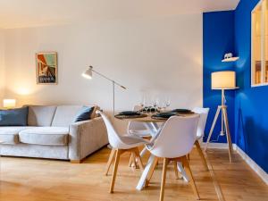 een woonkamer met een tafel, stoelen en een bank bij Apartment l'Hermitage-3 by Interhome in Deauville +16 foto's