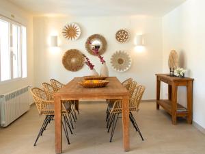a dining room table with chairs and mirrors on the wall at Villa Pax et Lucis by Interhome in Benissa