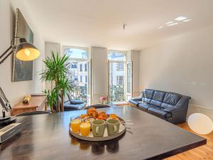 a living room with a table with a tray of oranges at Apartment An'Alré by Interhome in Auray