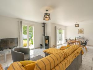 a living room with a couch and a tv at Holiday Home Villa Margarin by Interhome in Les Mathes
