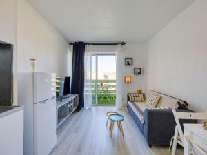 a living room with a couch and a refrigerator at Apartment Les Pins by Interhome in Narbonne-Plage