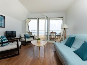 a living room with a couch and a table at Apartment Saint Sieu by Interhome in Lancieux