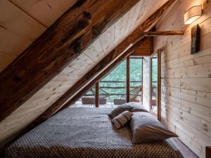 a bed in the attic of a cabin at Chalet Il Gianlupo Grigio by Interhome in Bognanco