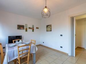 a dining room with a table and chairs at Apartment Mimosa by Interhome in Gazzelli +16 photos