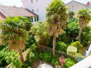 an aerial view of a garden with palm trees at Apartment Maison Simonne by Interhome in Biarritz