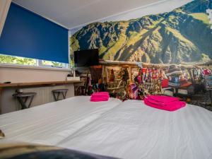a bedroom with a large bed with a mountain backdrop at Holiday Home Groepsaccommodatie Diever by Interhome in Diever