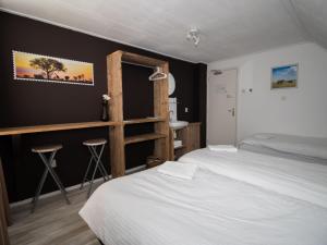 a bedroom with a white bed and a black wall at Holiday Home Groepsaccommodatie Diever by Interhome in Diever