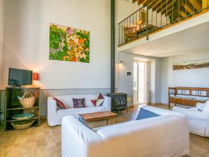 a living room with white couches and a tv at Holiday Home Marte by Interhome in Pereta +37 photos