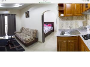 a living room with a couch and a bed at Junior Apartment in Pattaya