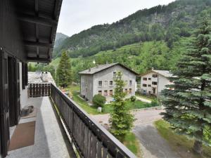 a balcony of a house with a view of a mountain at Apartment Isola di Madesimo Apartments-3 by Interhome in Isola