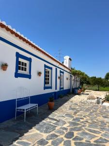 a blue and white building with a bench in front of it at Horta do Monte in Estremoz