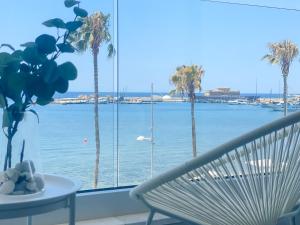 a view of the ocean from a room with a bench at Phaedrus Living: Marina Sea View Flat 214 Gold in Paphos