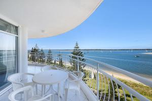 a balcony overlooking a beach with a view of the ocean at The Atrium Resort in Gold Coast