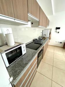 a kitchen with a sink and a microwave at La Francisca II in Formosa