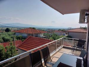 a balcony of a house with a table and chairs at Pablo Boutique Rooms in Vétrina