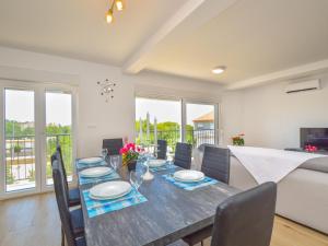 a dining room with a table and chairs at Holiday Home Milena by Interhome in Pakoštane +38 photos