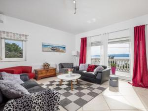 a living room with two couches and a table at Holiday Home Villa sunset view by Interhome in Senj