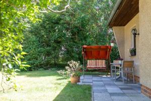eine Terrasse mit einem Tisch und einem Stuhl im Hof in der Unterkunft Ferienhaus Krohse in Potsdam
