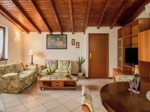 uma sala de estar com sofás e uma mesa em Apartment Azalea by Interhome em Lucino