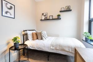 a bedroom with a bed and a table at Stunning Scandi Abode in Manchester Parking in Manchester