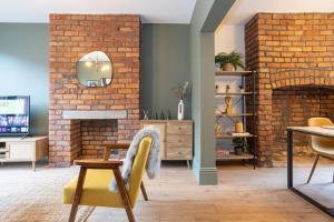 a living room with a brick wall at Stunning Scandi Abode in Manchester Parking in Manchester
