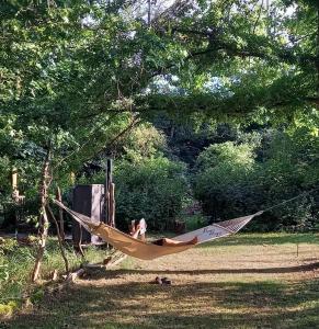 a woman laying in a hammock in a tree at einfachlosmachen-BulliBus 