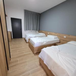 una camera d'albergo con tre letti di Hotel Erandi a Rinas