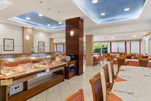 Stefania Hotel في أمارنثوس: مطعم بطاولات وكراسي وبوفيه