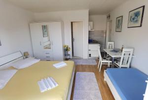 a bedroom with a bed and a table and chairs at Apartment Jadranka in Makarska