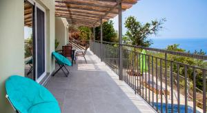 a balcony with chairs and a view of the ocean at Villa Marina in Kalamitsi