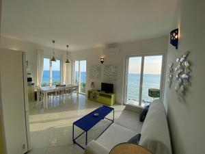a living room with a couch and a view of the ocean at Blu OltreMare in Acciaroli
