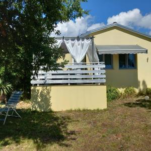 a house with a large deck in the yard at Apartment Helena in Kanfanar