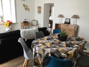 a living room with a table and a couch at Appartement ravissant en bordure du Doubs 