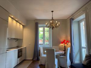 a kitchen and dining room with a table and chairs at Appartme Stampa 1 in Milan