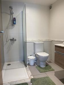 a bathroom with a toilet and a glass shower at Marrassi Marina spacious chalet in El Alamein