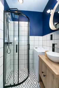 a bathroom with a glass shower and a sink at Apartament Lwowska in Lublin +15 photos