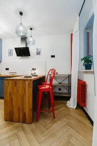 a red chair sitting at a desk in a room at Apartament Lwowska in Lublin