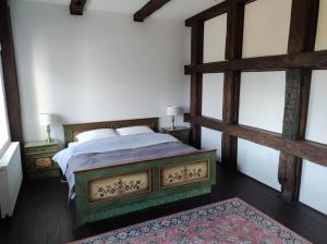 a bedroom with a bed and two windows at Srokowski Dwór 1 - Mazurski Dwór - 450m2 in Srokowo