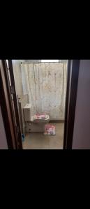 a small bathroom with a toilet and a curtain at Amwaj north Coast 