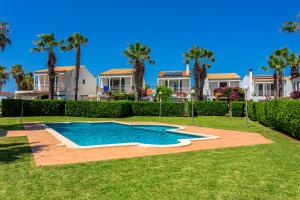 a swimming pool in a yard with palm trees at Aloes in Sa Caleta +21 photos