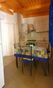 a kitchen with a table and chairs in a room at Camping Onda Azzurra in Ortona