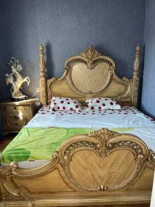 a bedroom with a bed with a wooden frame at Erik in in Tbilisi City