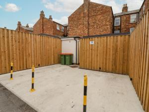 a parking lot in front of a wooden fence at Seascape Villa in Filey