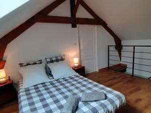 um quarto com uma cama com um cobertor xadrez em Gîte Marcillat-en-Combraille, 3 pièces, 6 personnes - FR-1-489-369 em Marcillat-en-Combraille