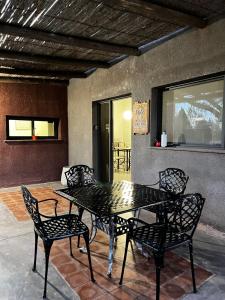 a black table and chairs on a patio at Casa Vergara I in Villa Unión